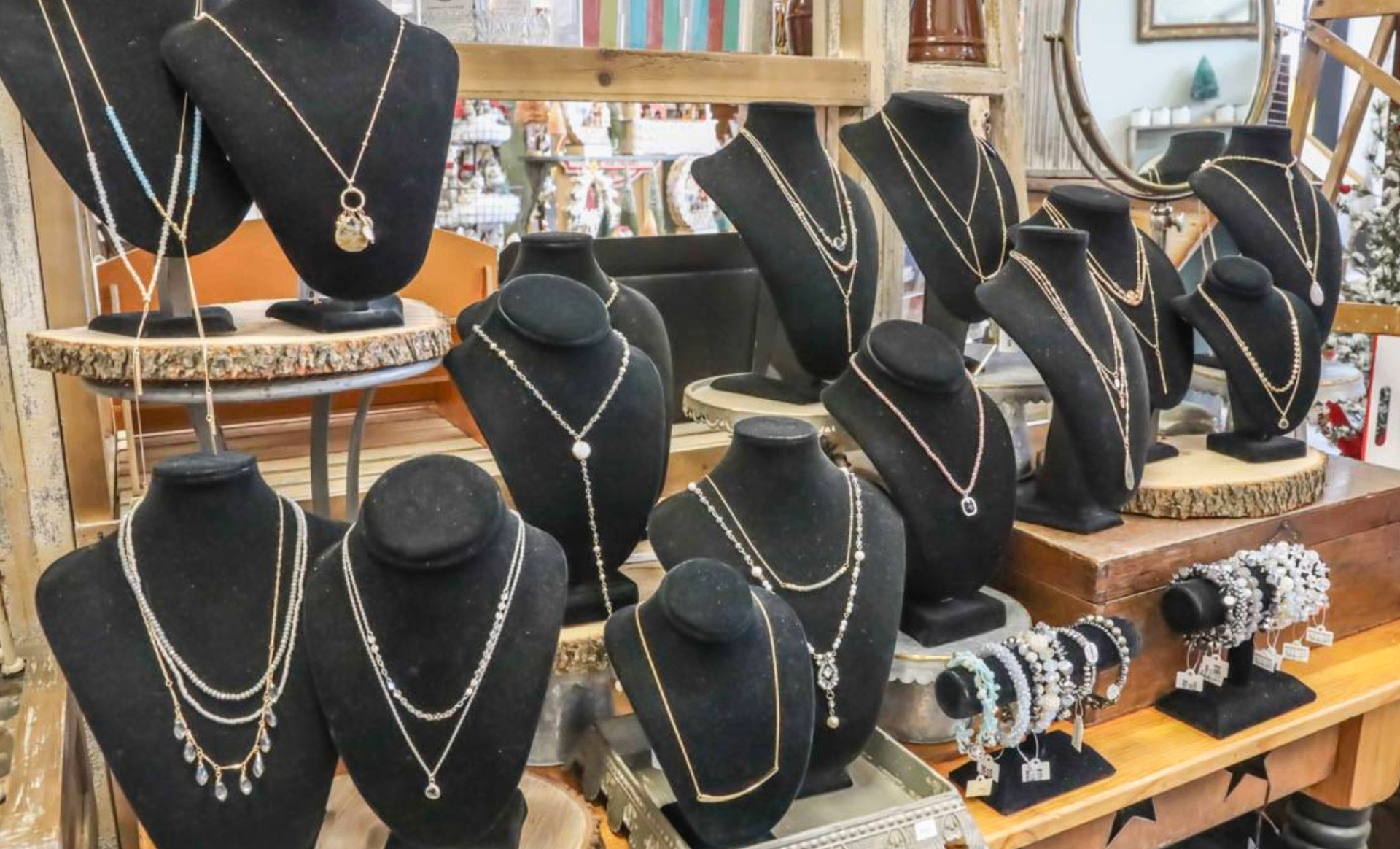 Black velvet busts displaying handcrafted necklaces and bracelets.